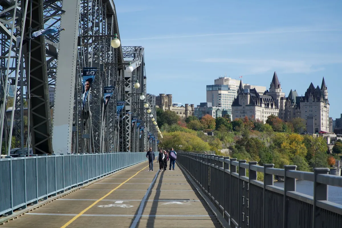 The Alexandra Bridge connecting Ottawa to Gatineau with Parliament Hill silhouette at dusk