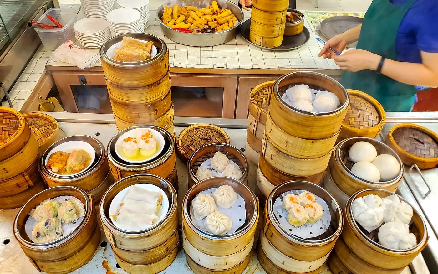 Sea King dim sum spread with bamboo steamers, rice rolls, buns, and small shared plates