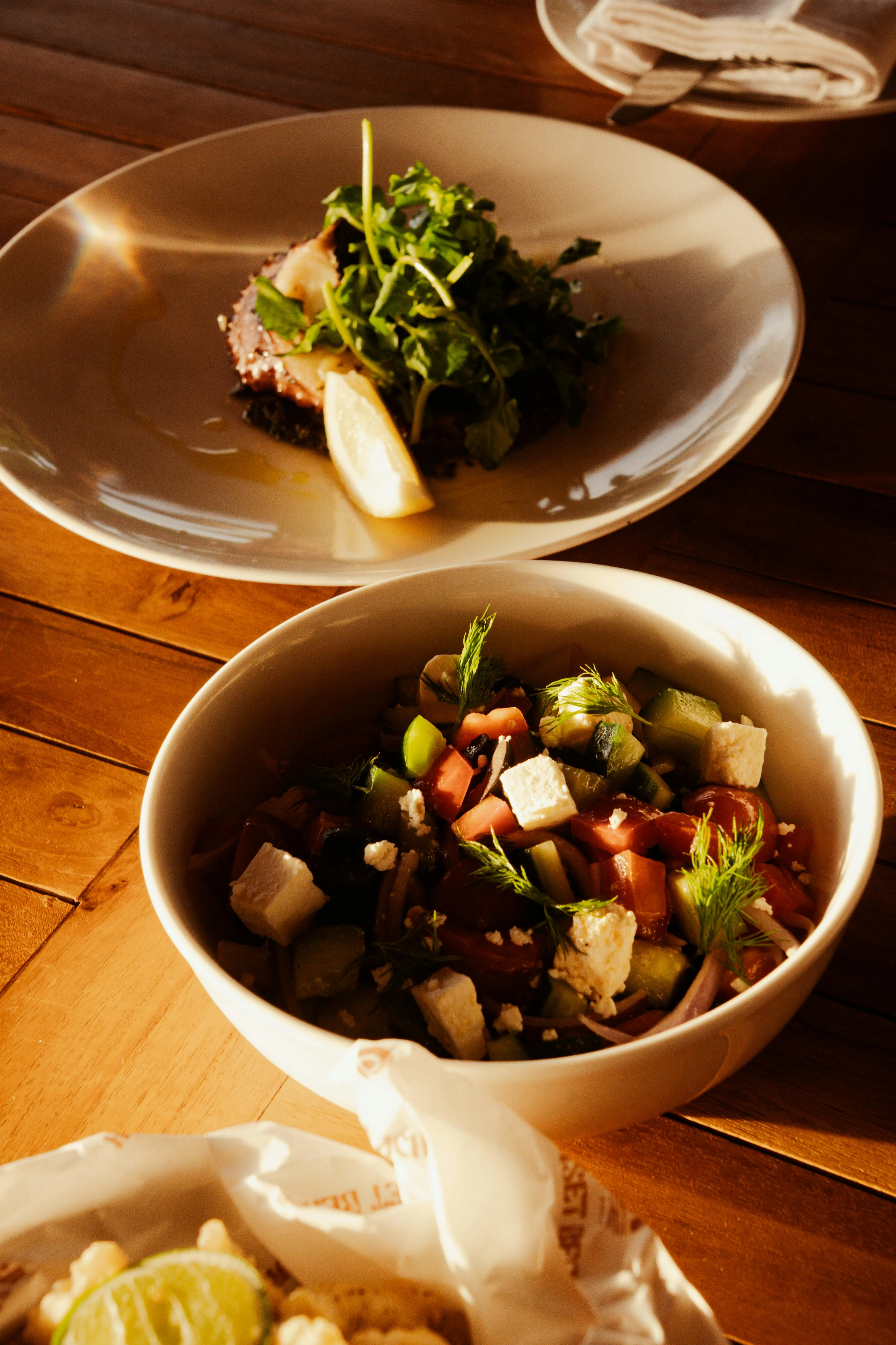 Mediterranean shared plates, grilled mains, and mezze on a restaurant table