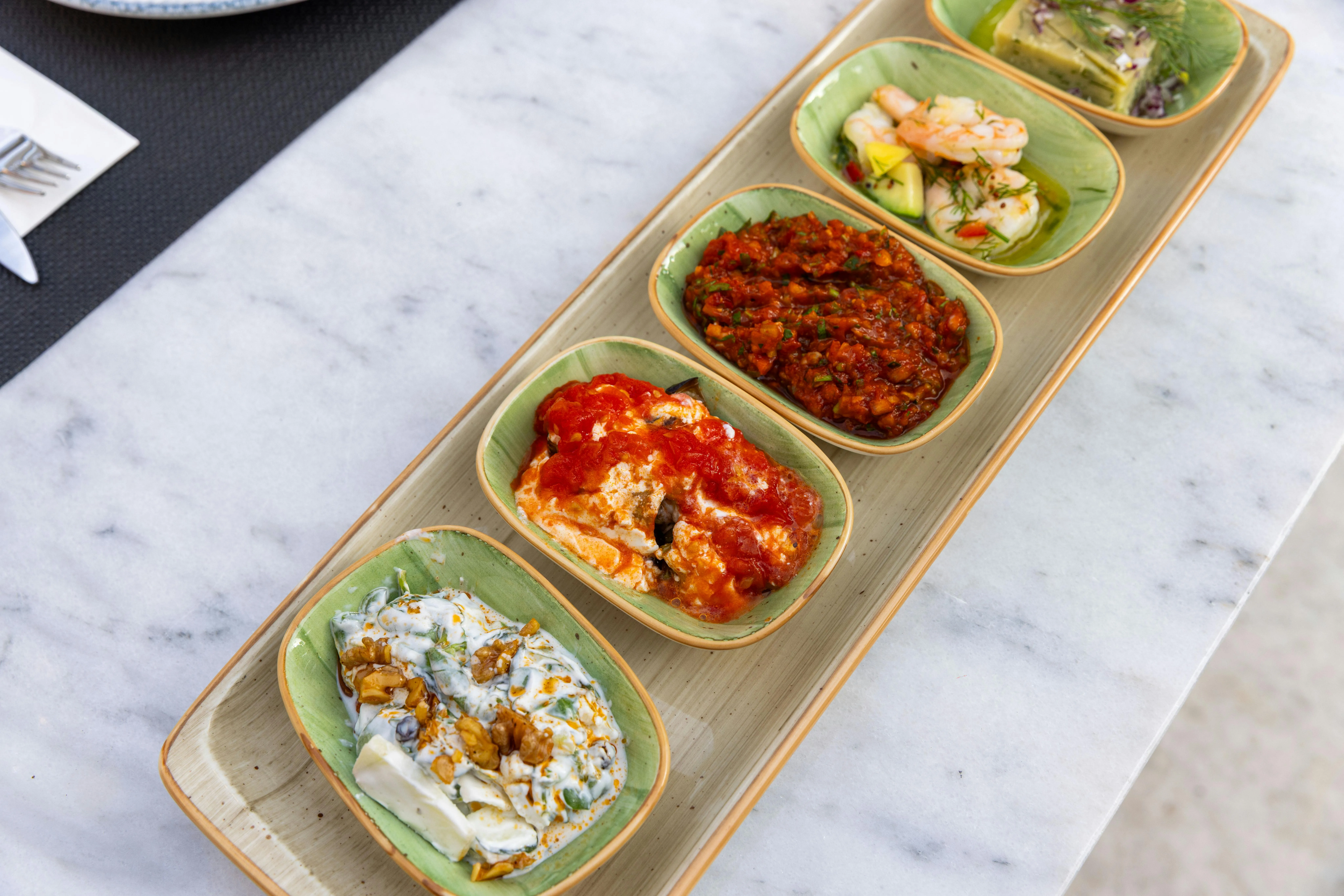 Small plates, candlelight, cocktails, and Mediterranean dinner sharing