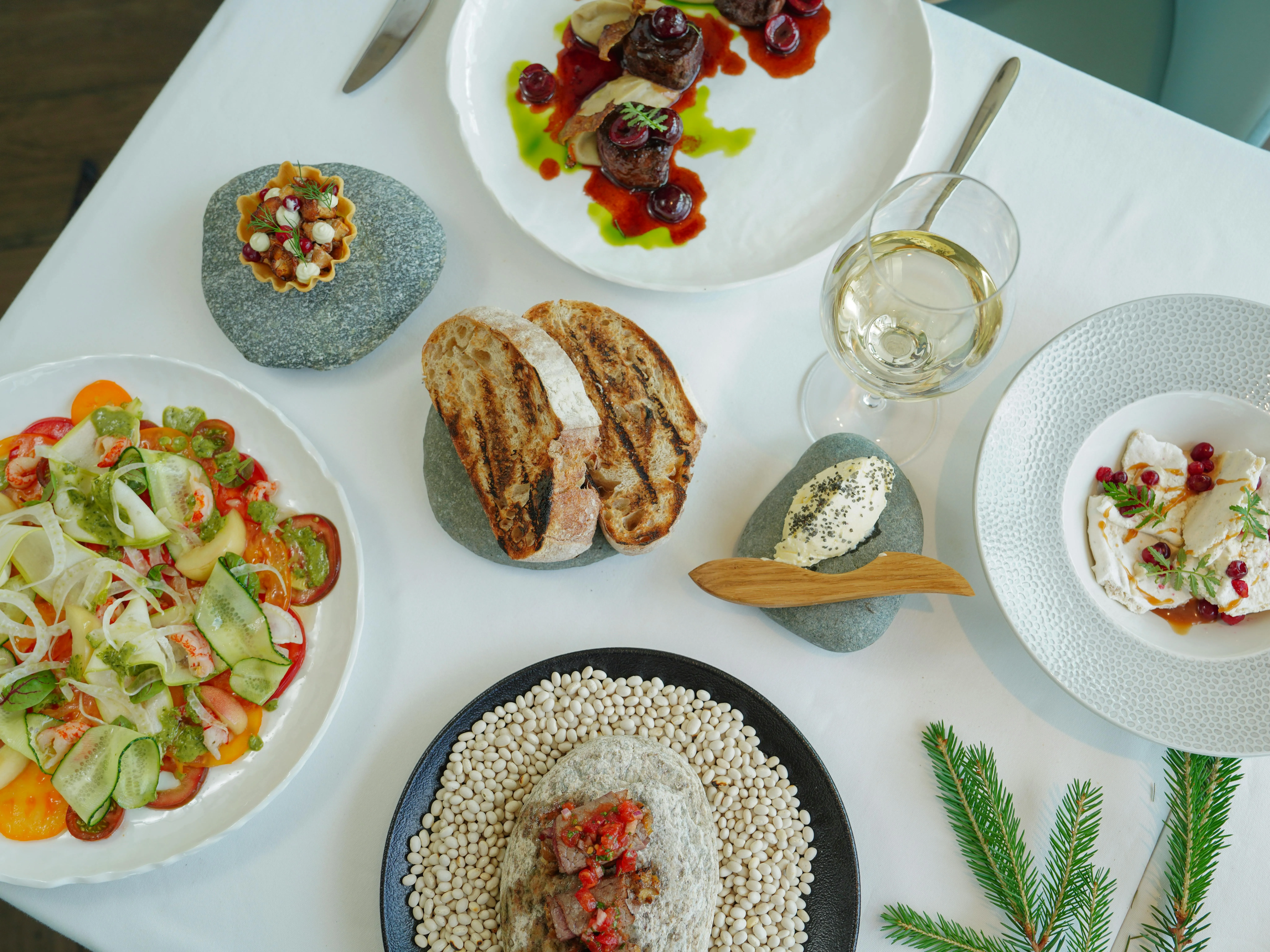 Mediterranean table contrasting casual grill plates with upscale plated seafood