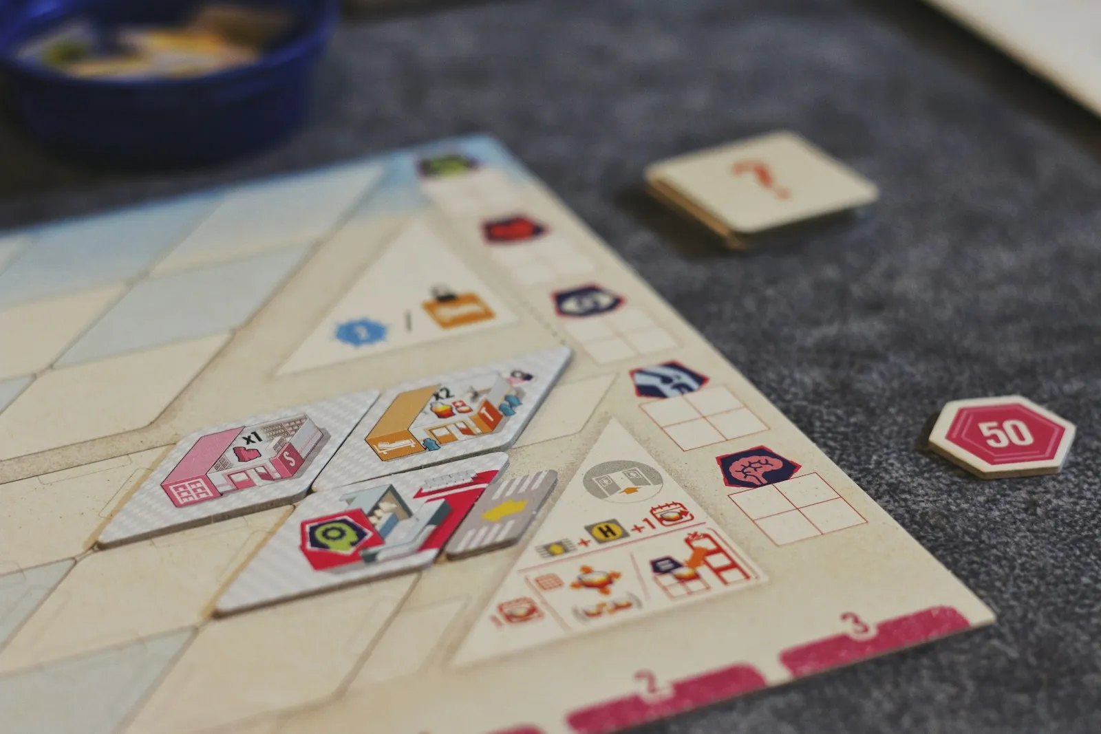 Board game tiles and tokens laid out on a table