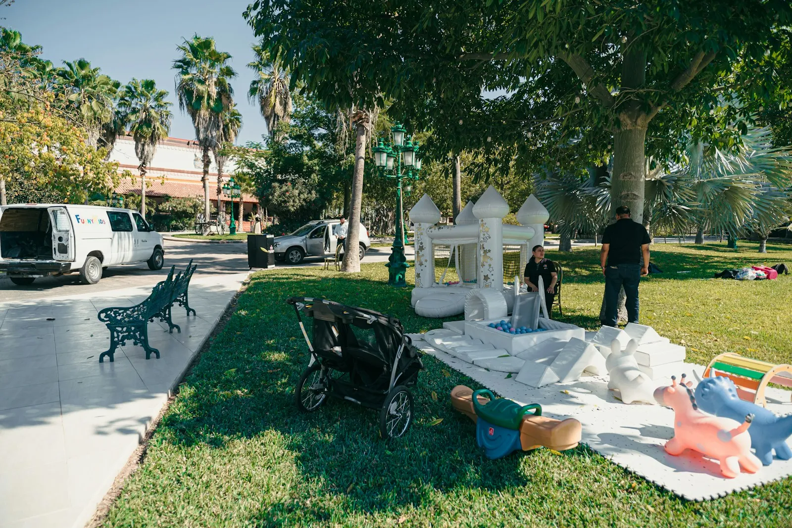 Delivery van unloading an inflatable at a backyard party