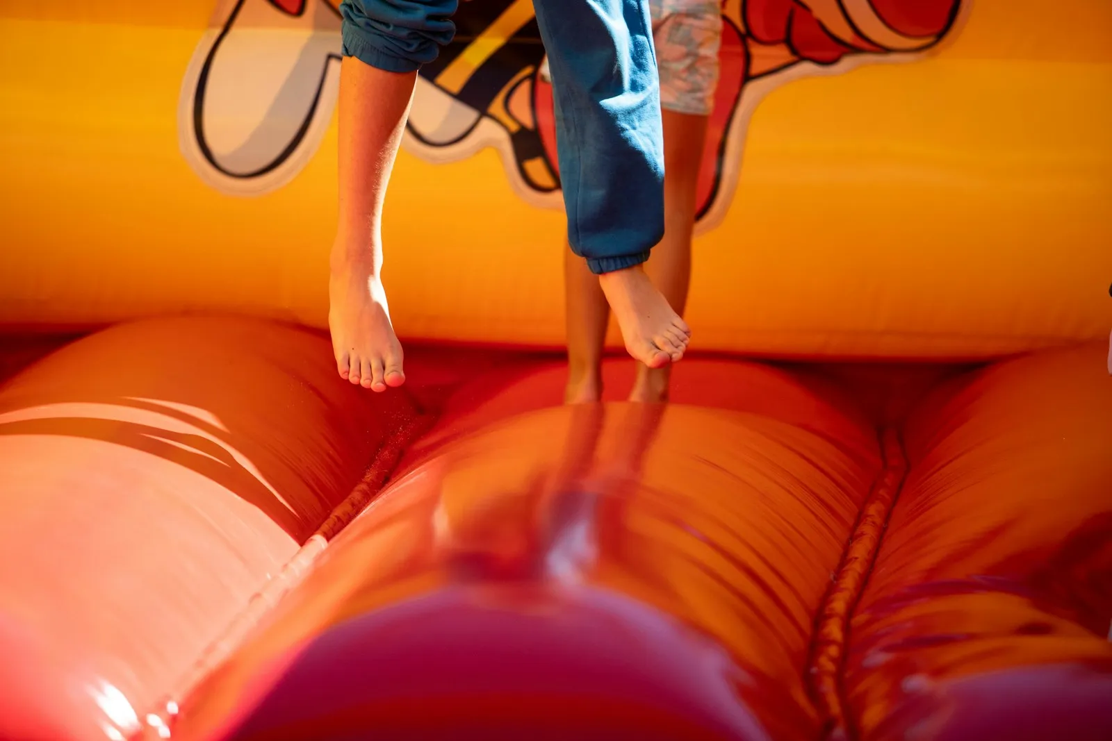 Kids playing in a bright inflatable bounce house