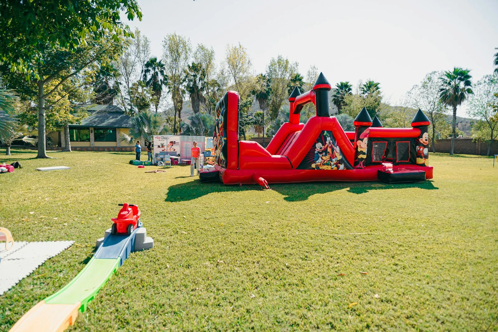 Colourful bounce house with a slide in a backyard