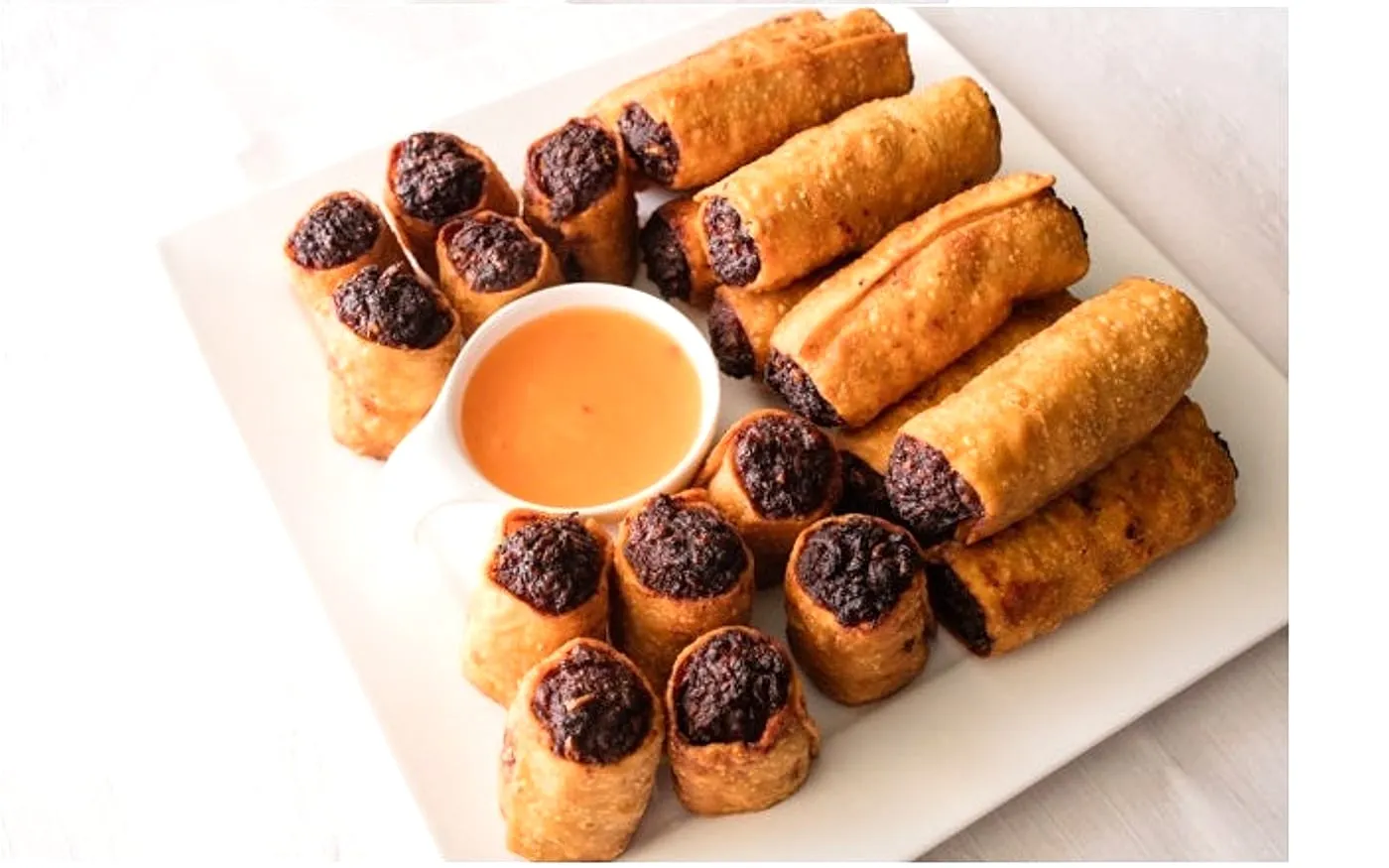 Golden Palace egg rolls arranged around dipping sauce for a classic Ottawa Chinese restaurant order