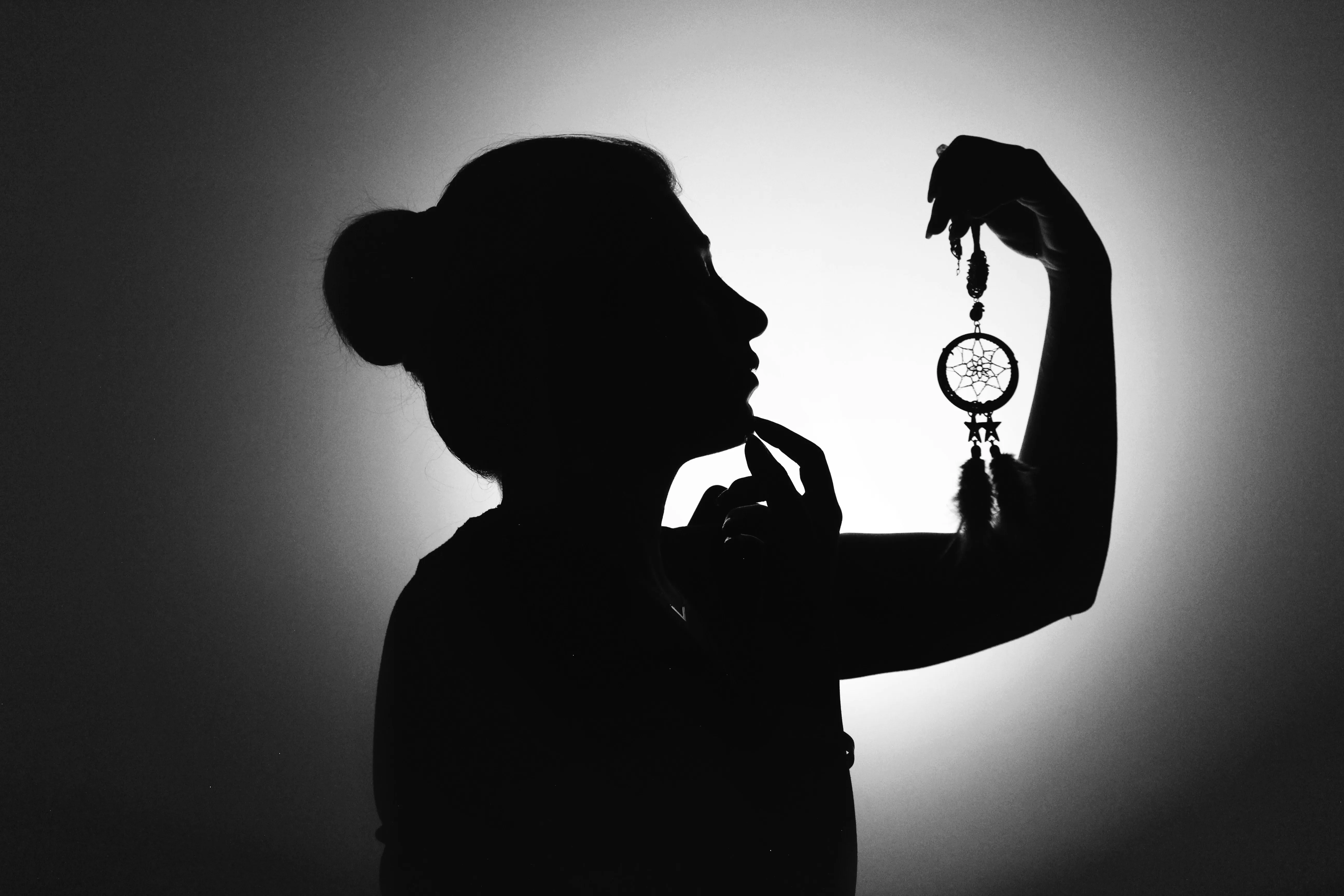 A silhouette of a person with a magnifying glass — capturing the investigative spirit of Crossroads