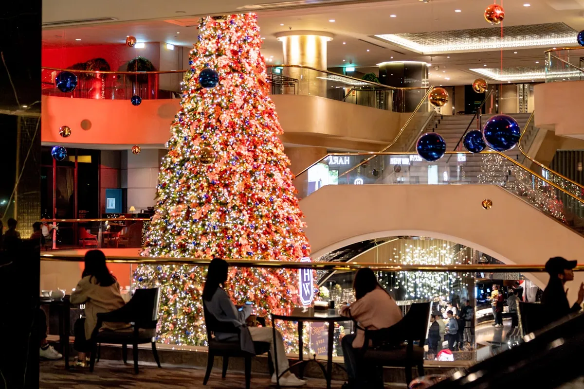 Busy shopping mall with holiday decorations and last-minute shoppers