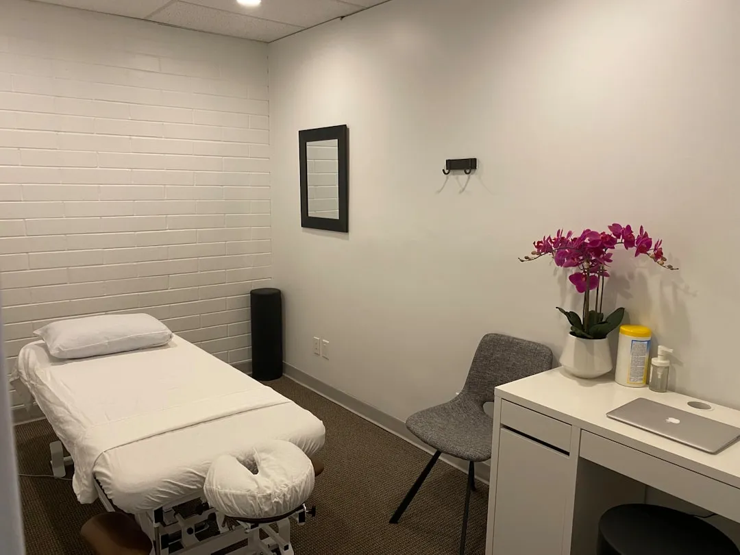 Massage therapist preparing a treatment room