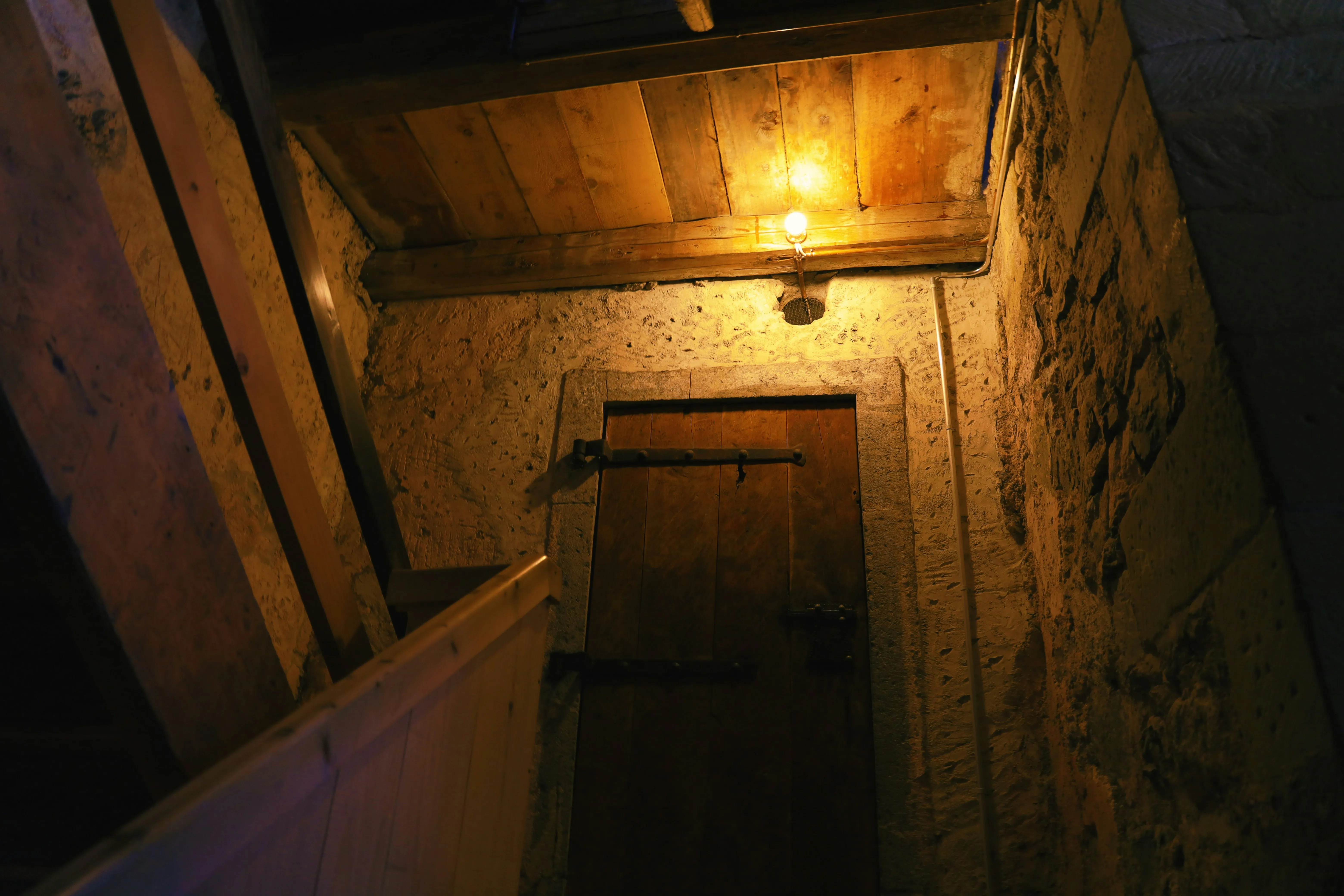 Escape room with mysterious dark atmosphere, locked door and dramatic lighting