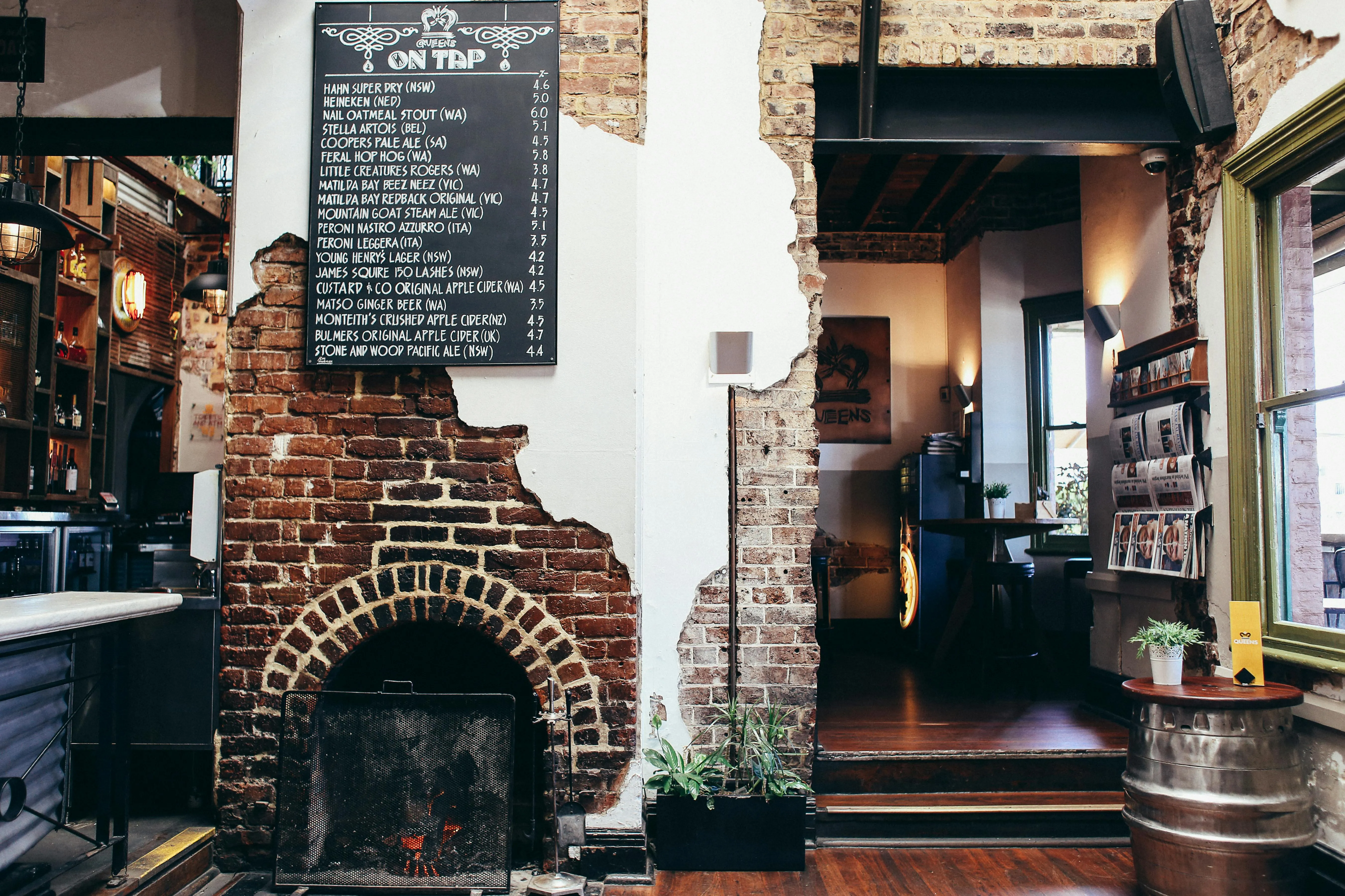 Sports bar interior with multiple TV screens above the bar