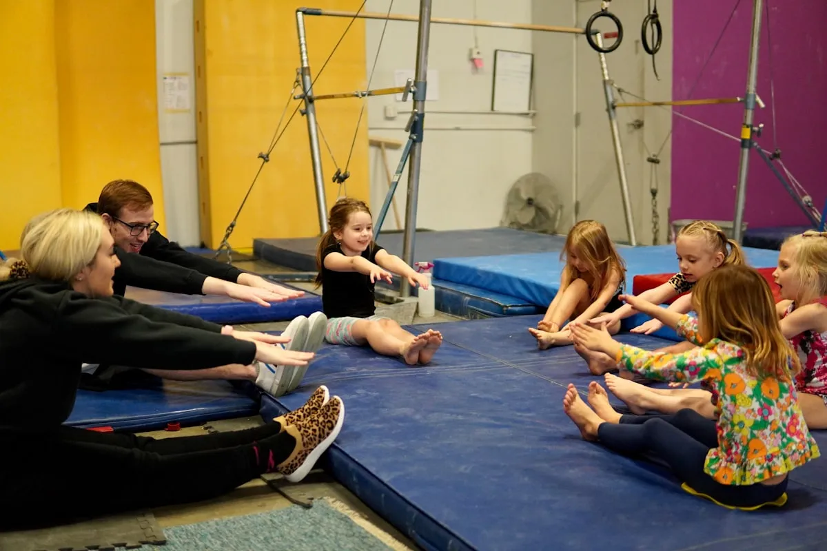 Kids practicing gymnastics on a soft floor