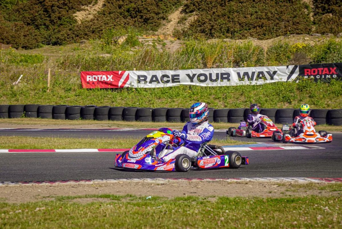 Children in junior go karts with safety gear and instructors
