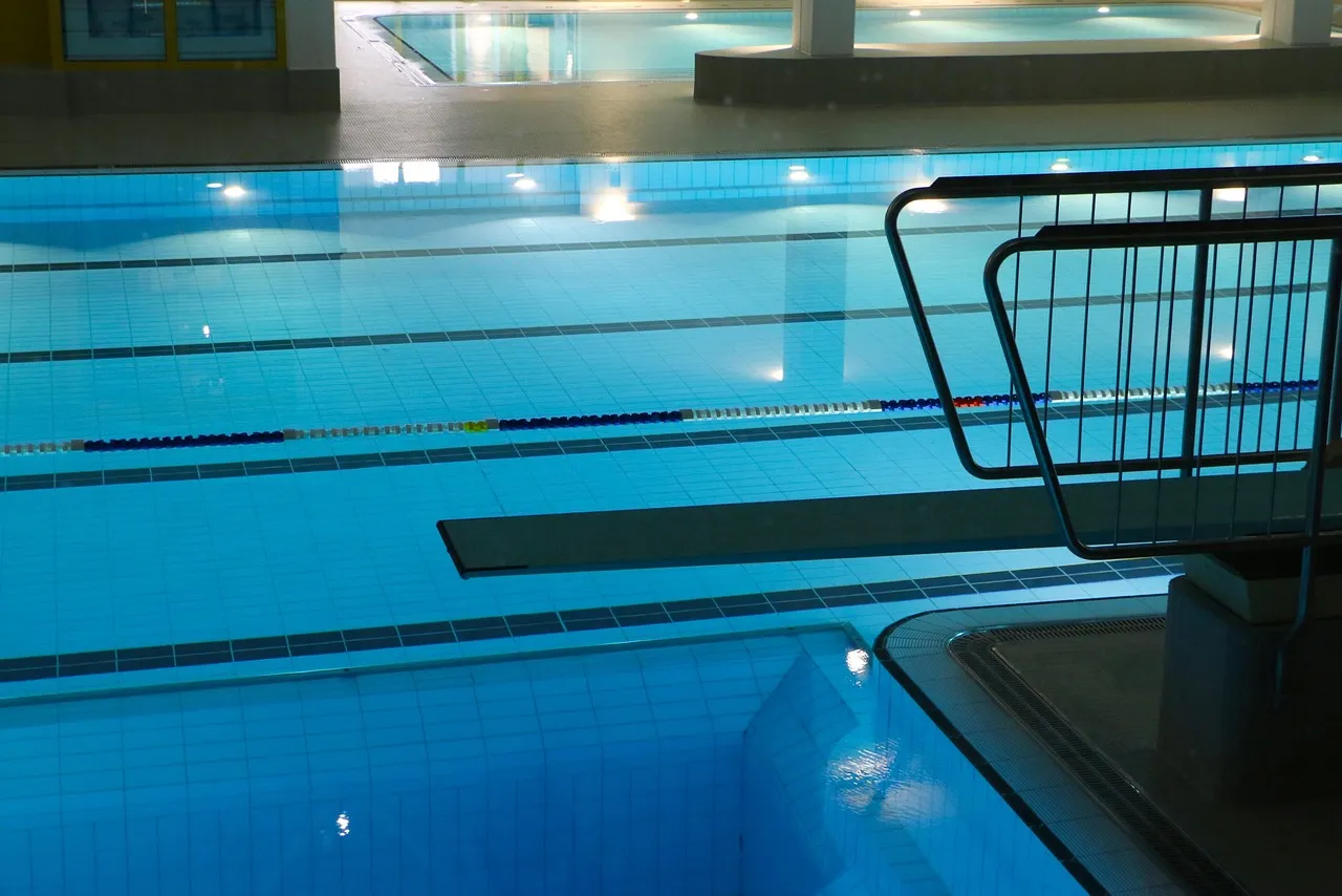 Indoor pool setting aligned with full-service gym amenities