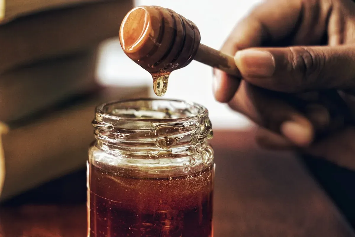 Maple syrup being poured over pancakes at sugar bush