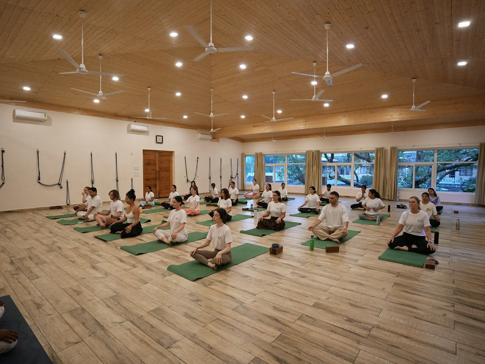 Community yoga class in a bright multipurpose room