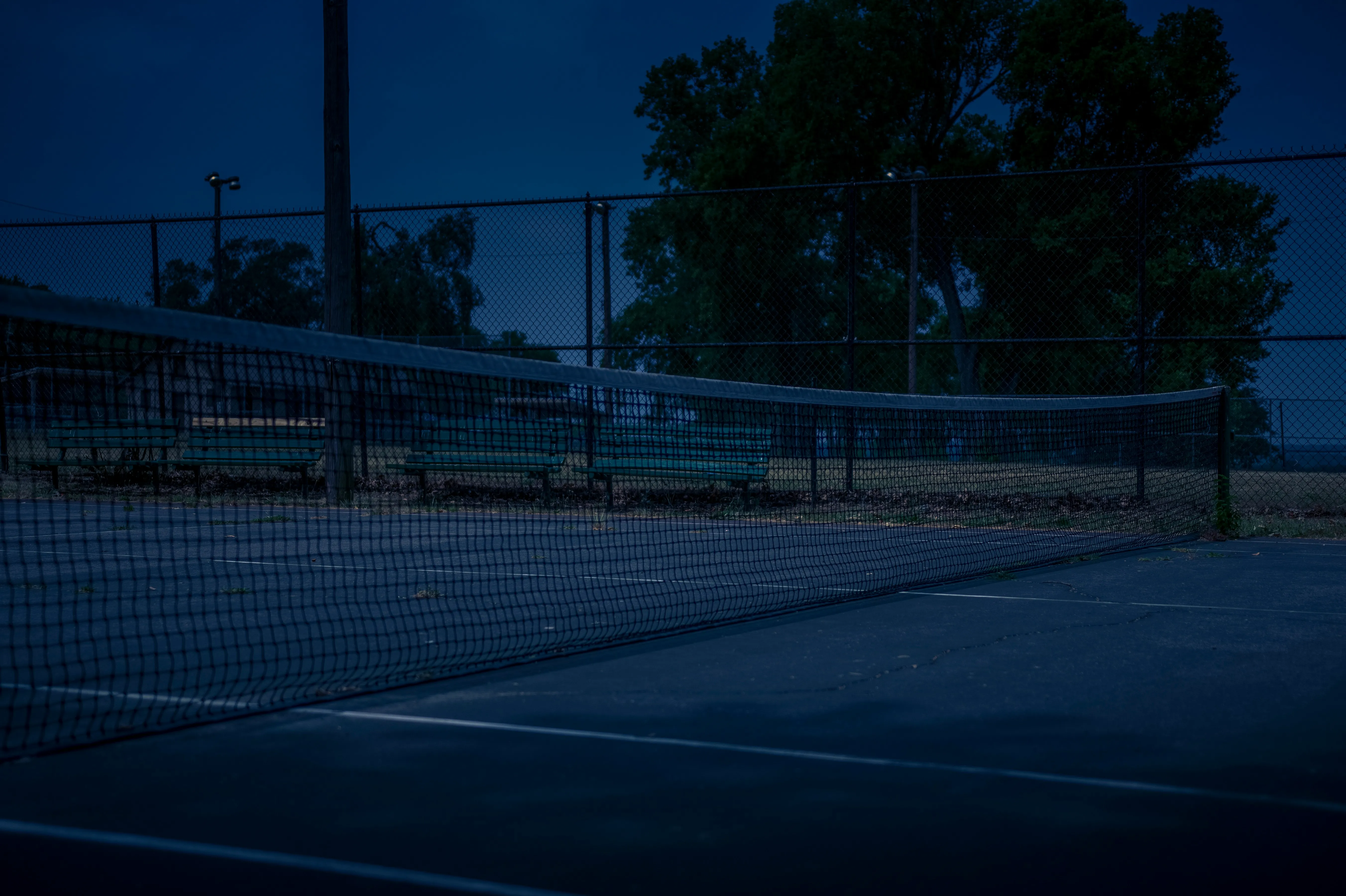 Lighted tennis courts in Ottawa at dusk