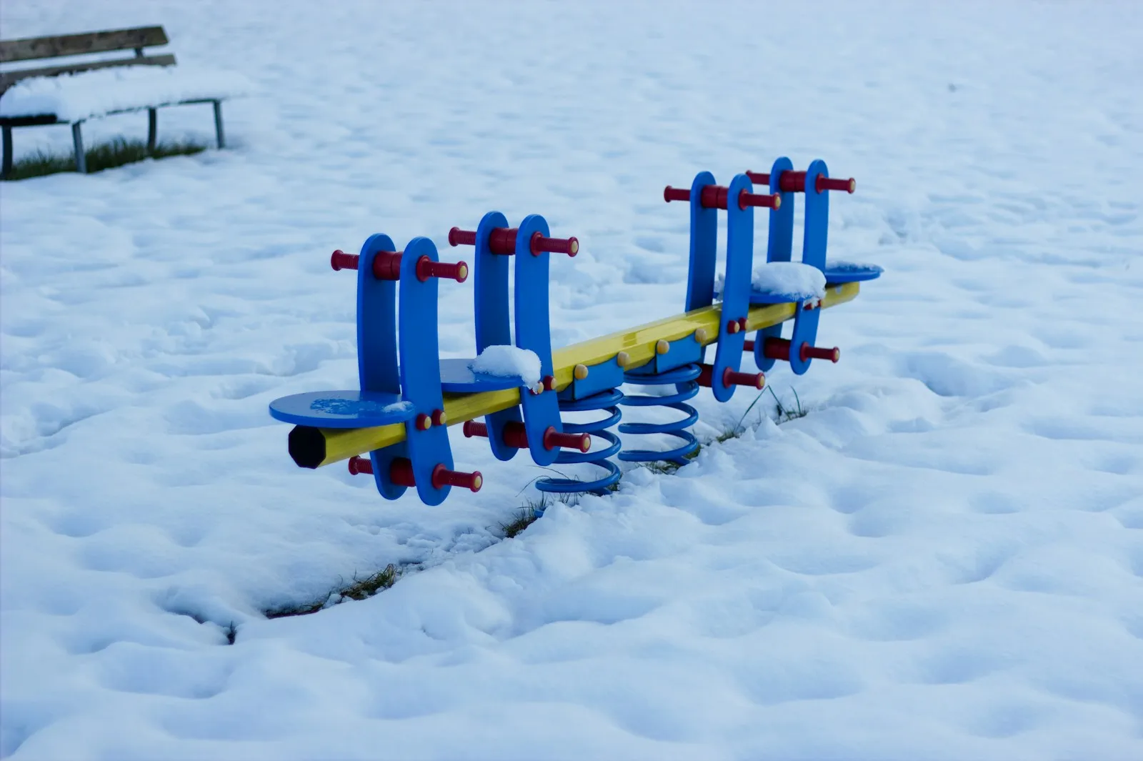 Families at a playground in changing seasons