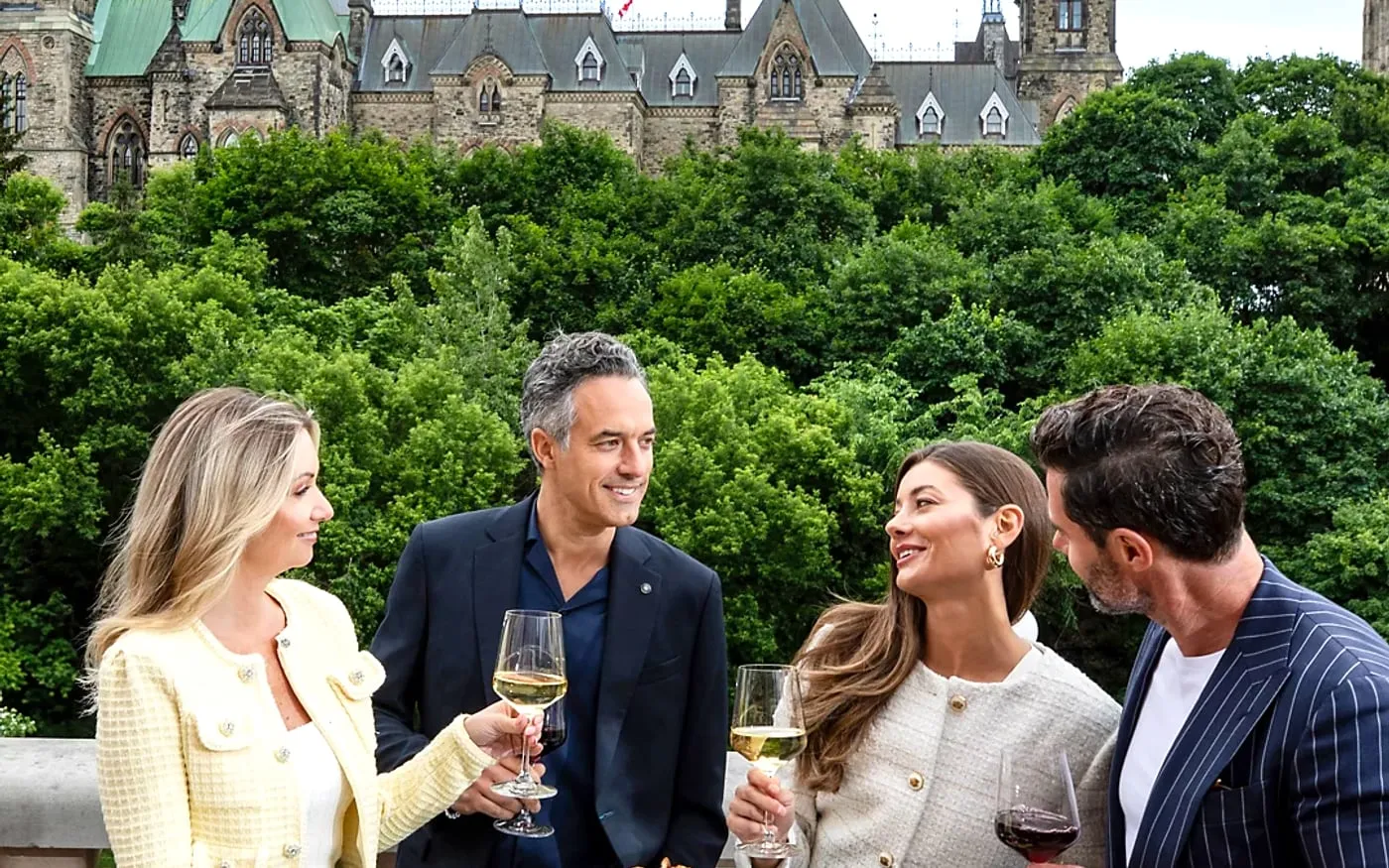 Group enjoying drinks at La Terrasse with Parliament Hill and Ottawa landmark views behind them