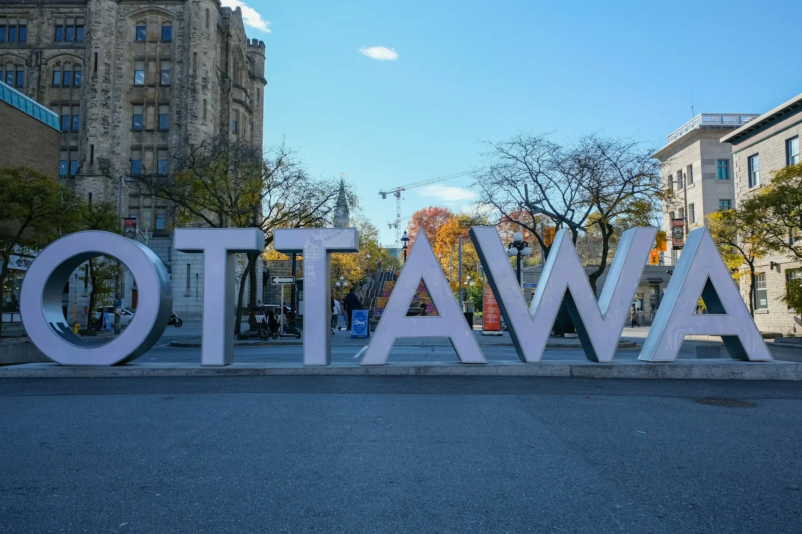 Ottawa sign in front of city buildings.