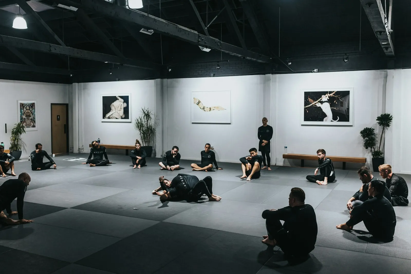 Students rolling up mats after class in a calm studio