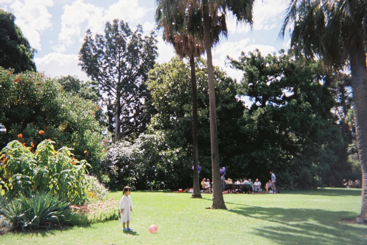 Kids running through a field at an outdoor party