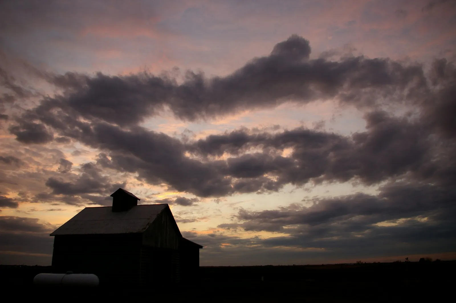 Family leaving a farm at sunset