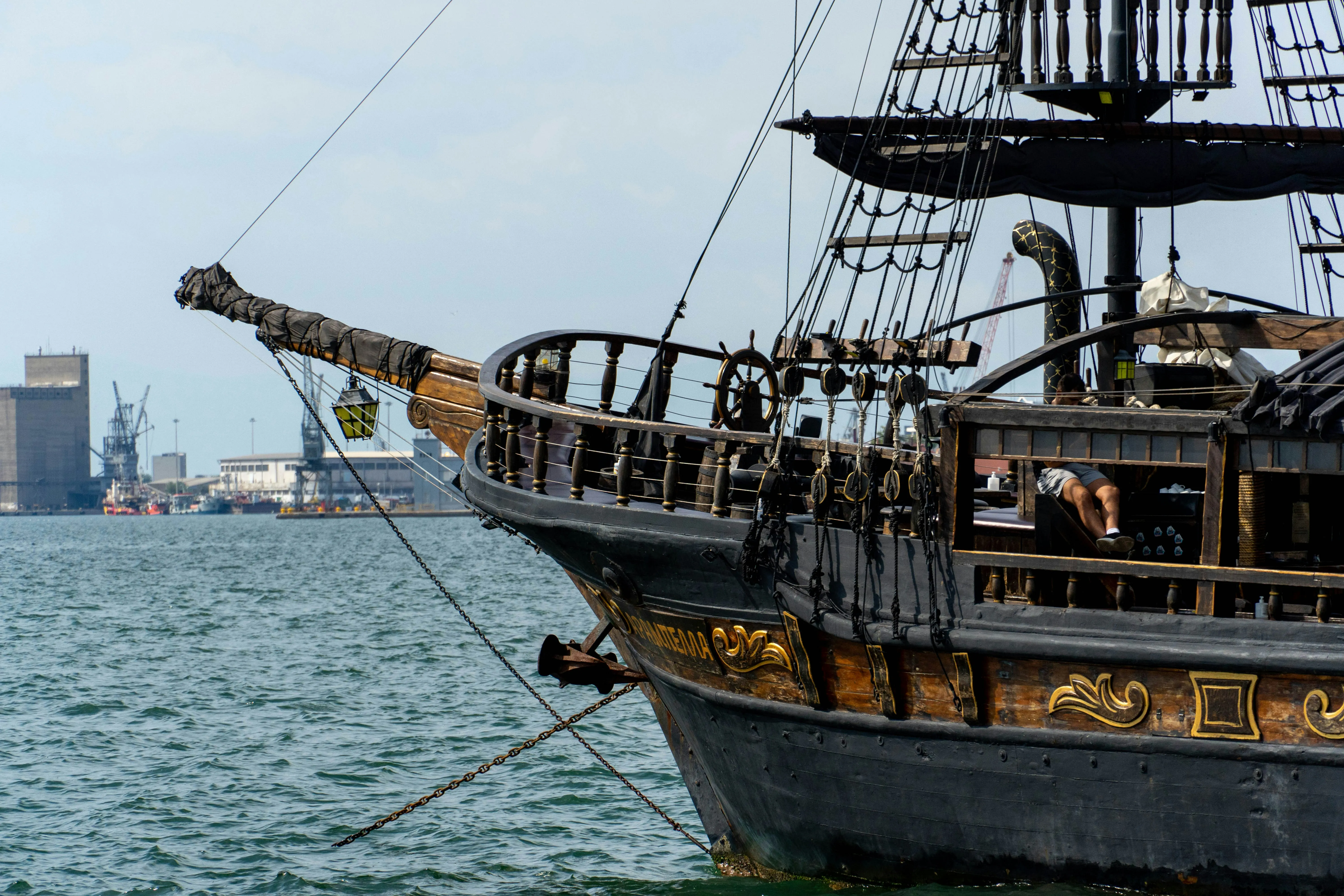 A pirate ship on the water at twilight — evoking the nautical mystery of The Pirate's Code