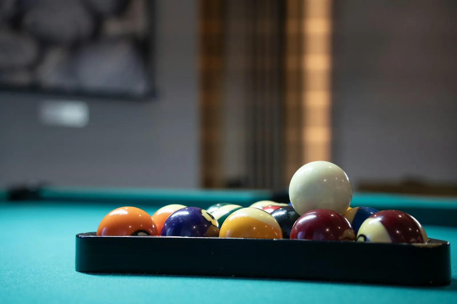 Pool balls and cues set up on a felt table