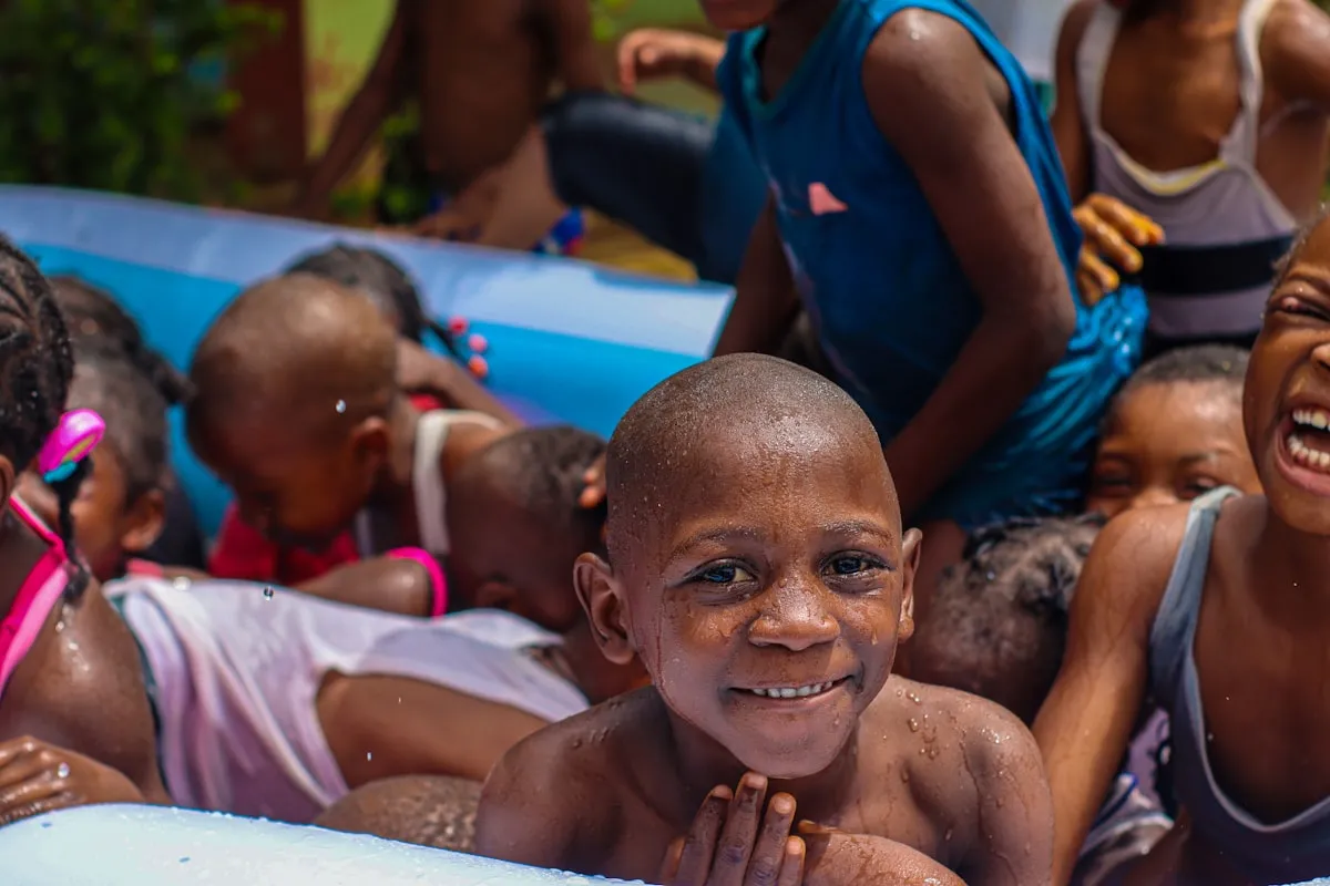 Kids splashing in a pool during a birthday party
