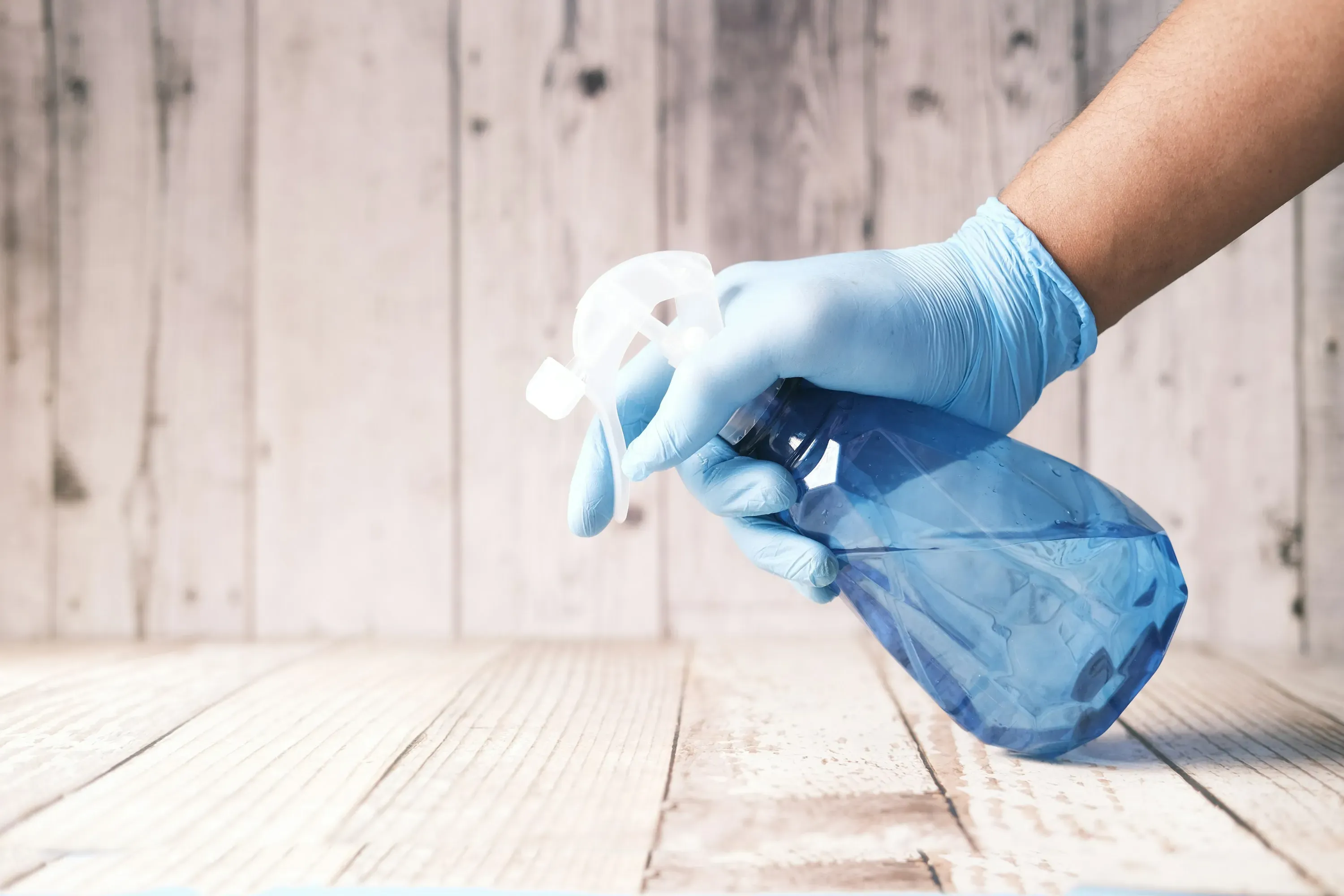 Professional cleaner wiping surfaces in a modern home.