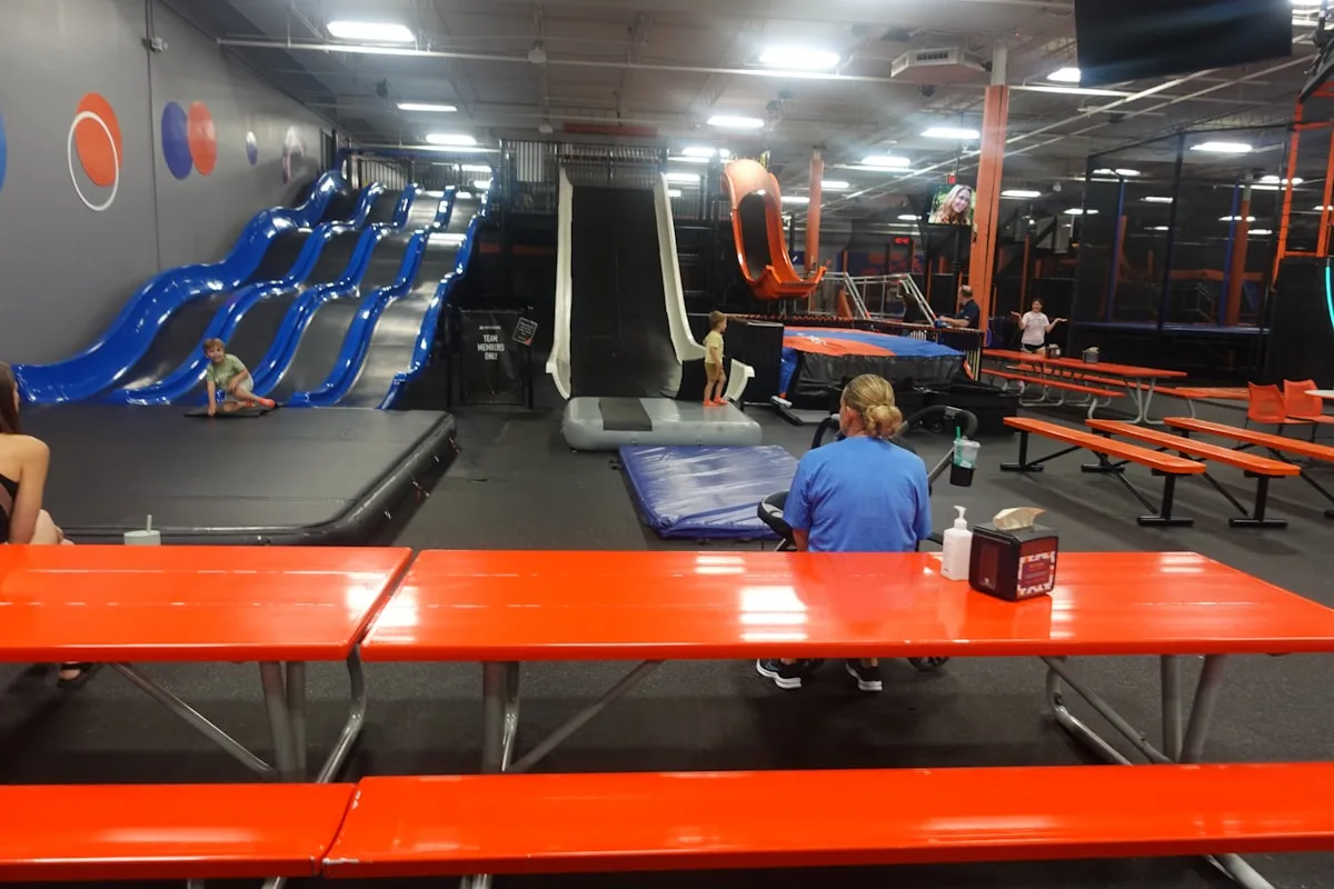 Kids jumping into a foam pit at a trampoline park