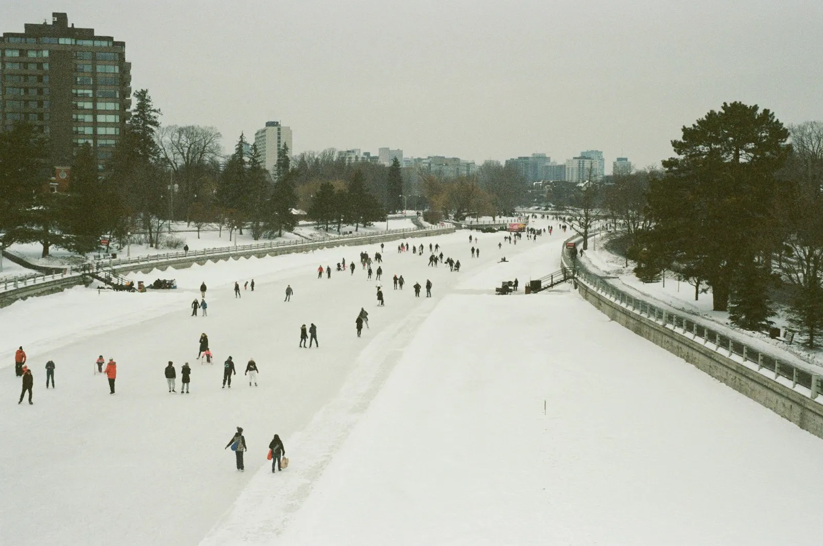 People walking through a snowy winter festival.