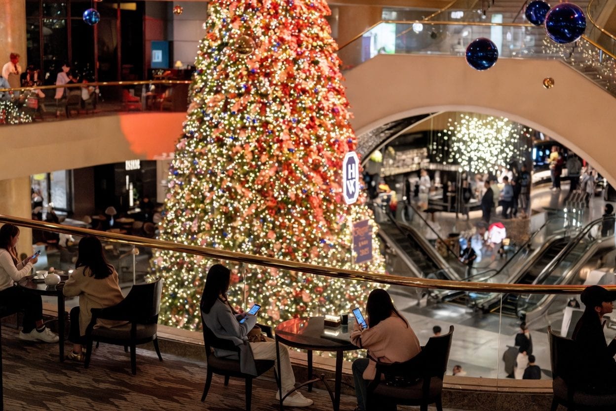 Busy shopping mall with holiday decorations and last-minute shoppers