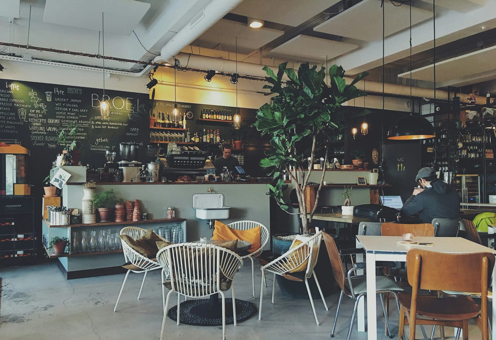 Cozy cafe interior with warm lighting and coffee cups.
