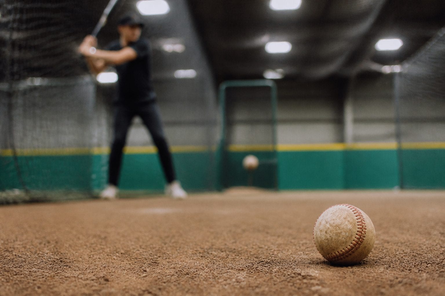 Softball batting practice at indoor cage