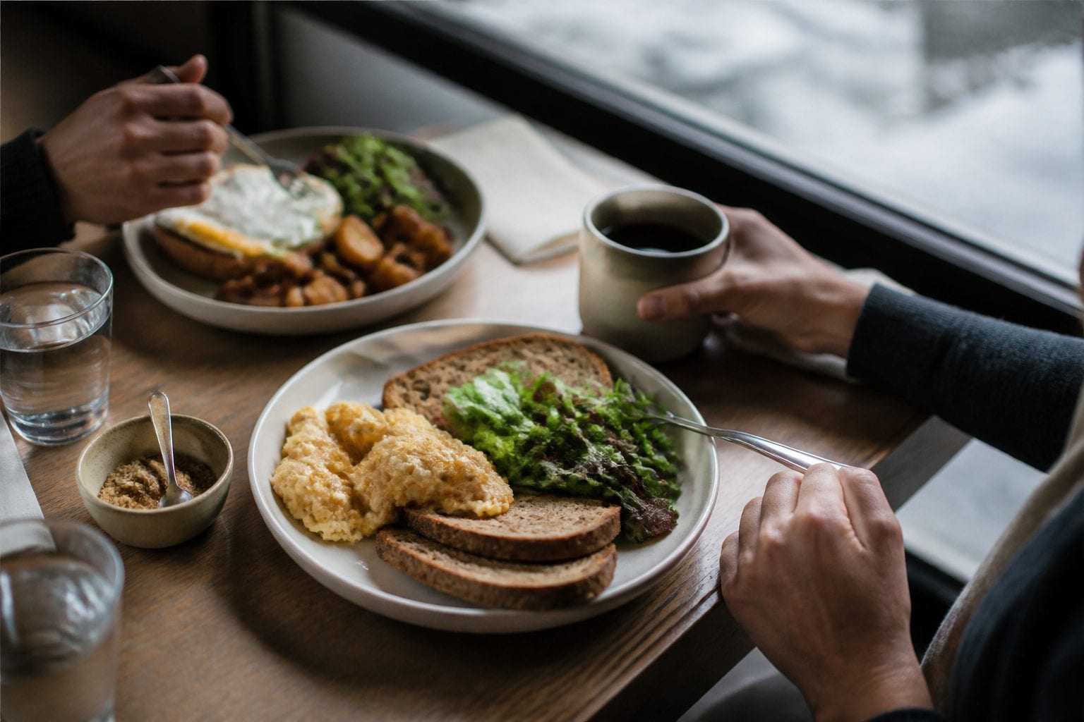 Breakfast plates, coffee, and morning light in an Ottawa restaurant