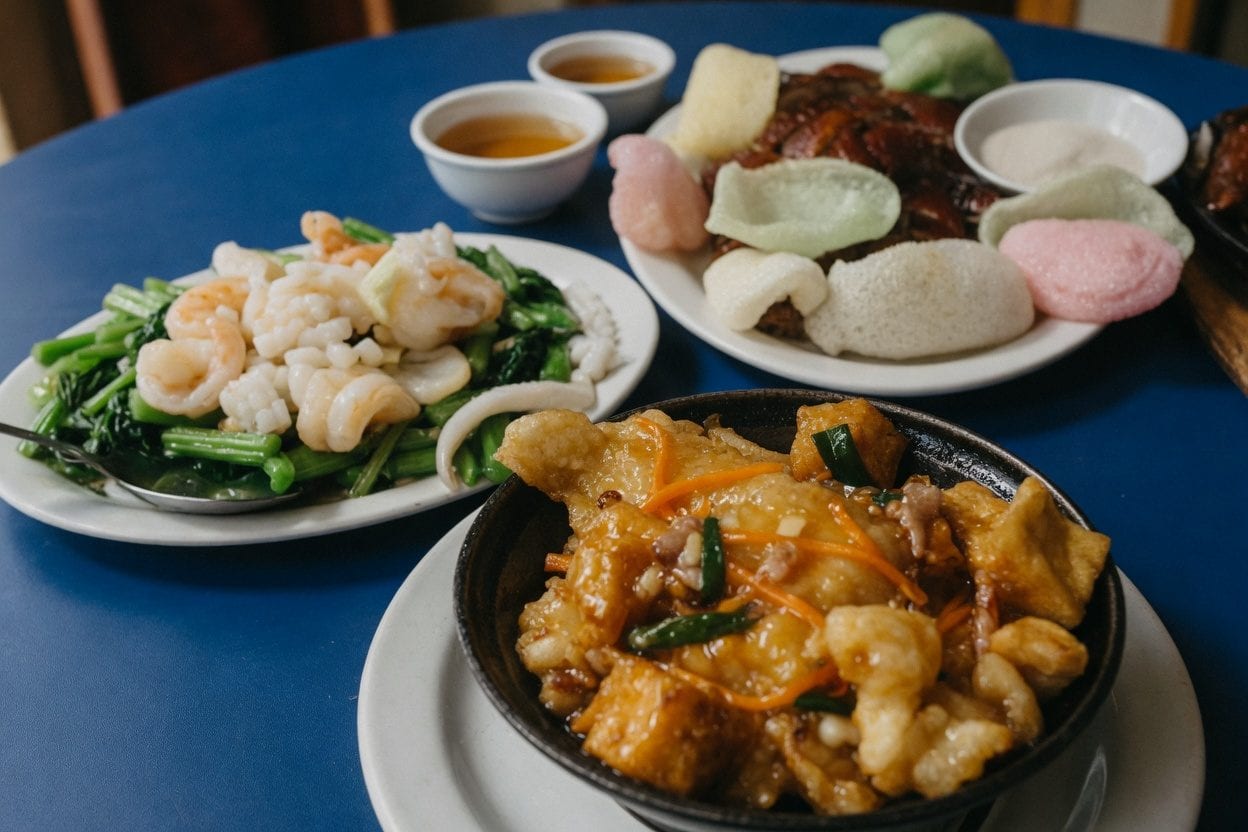 Royal Treasure shared Chinese dinner with roast meats, greens, rice, and sauced dishes on a blue table