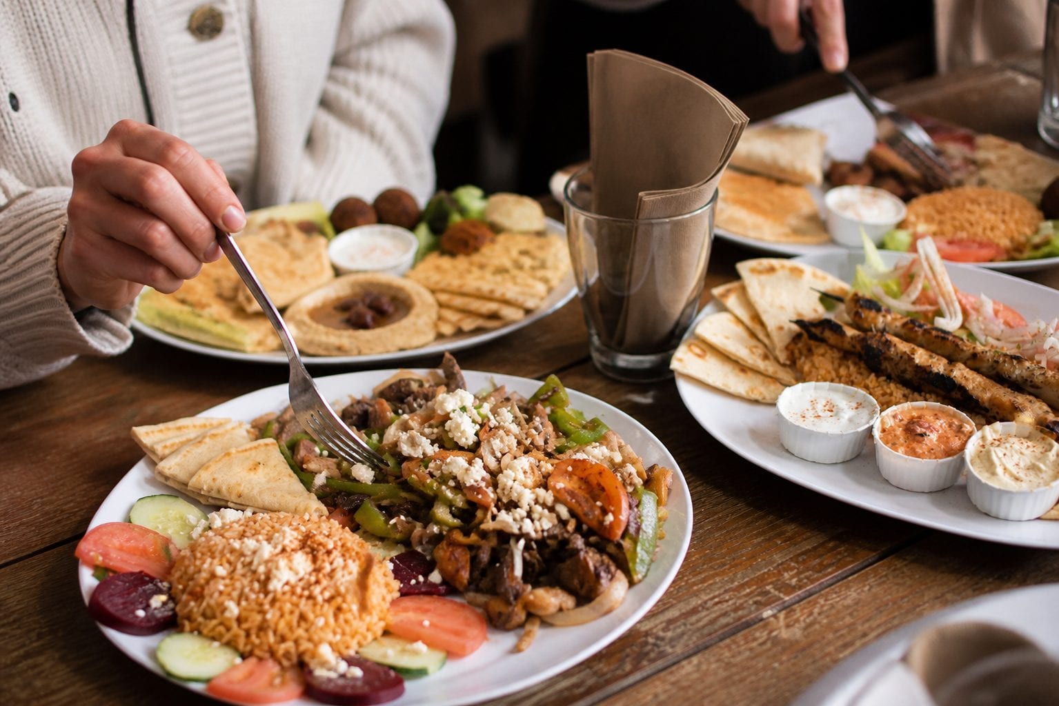Authentic Greek mezes plate with hummus, falafel, souvlaki and Greek rice
