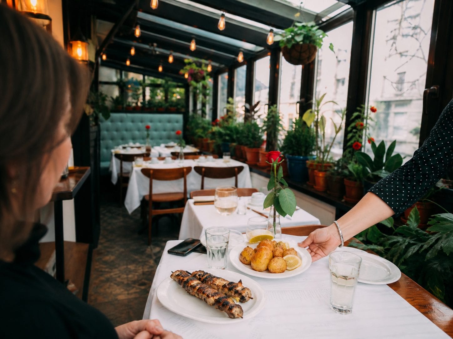 Traditional Greek taverna with grilled meat and lemon potatoes