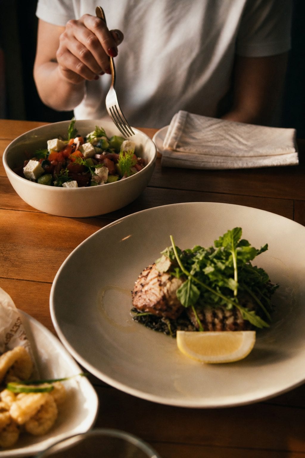 Mediterranean shared plates, grilled mains, and mezze on a restaurant table