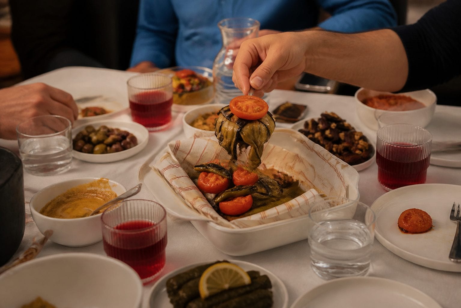 Mediterranean dinner ending with shared plates, drinks, and a warm restaurant-table atmosphere