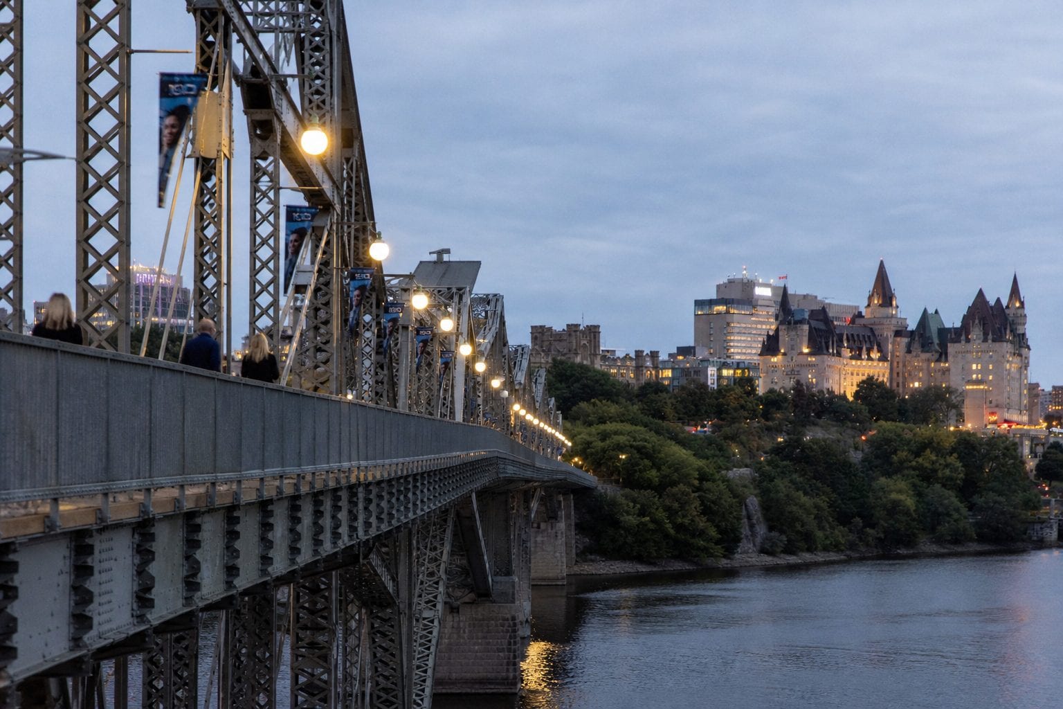 The Alexandra Bridge connecting Ottawa to Gatineau with Parliament Hill silhouette at dusk