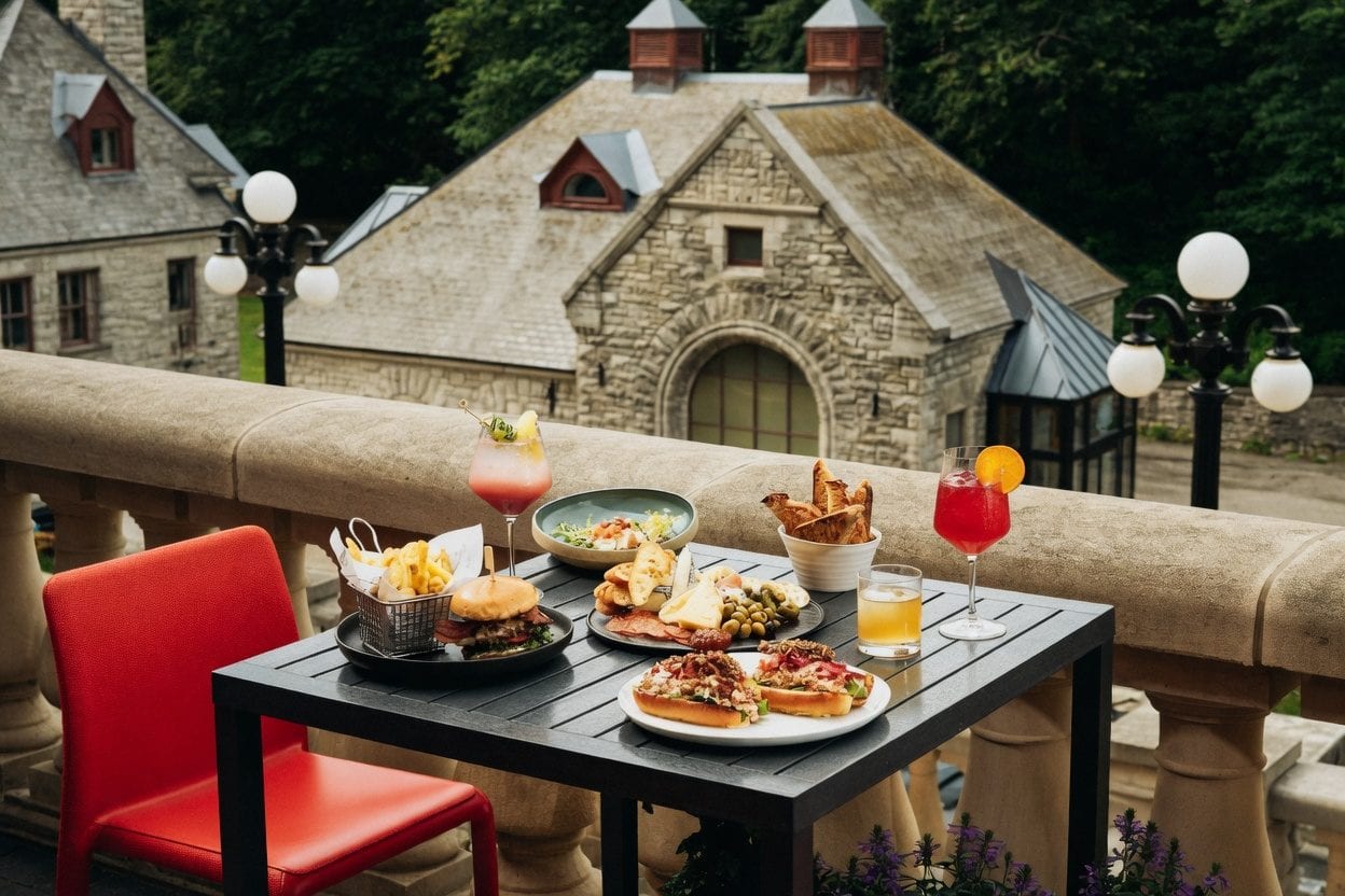 Fairmont La Terrasse table with drinks and Château Laurier stonework beside the Ottawa landmark view
