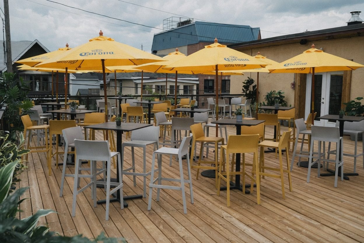 The Porch on Preston rooftop deck with bright yellow umbrellas and open-air group seating