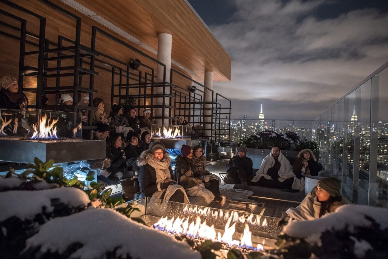 Copper Spirits and Sights rooftop seating with Ottawa skyline views at dusk