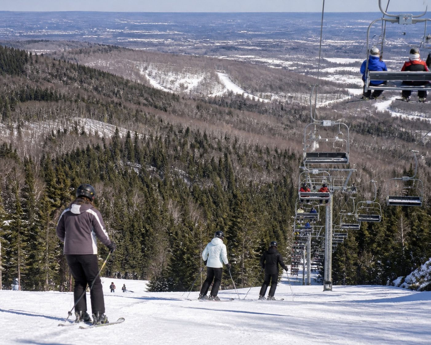 Camp Fortune ski hill with Gatineau Park treeline backdrop