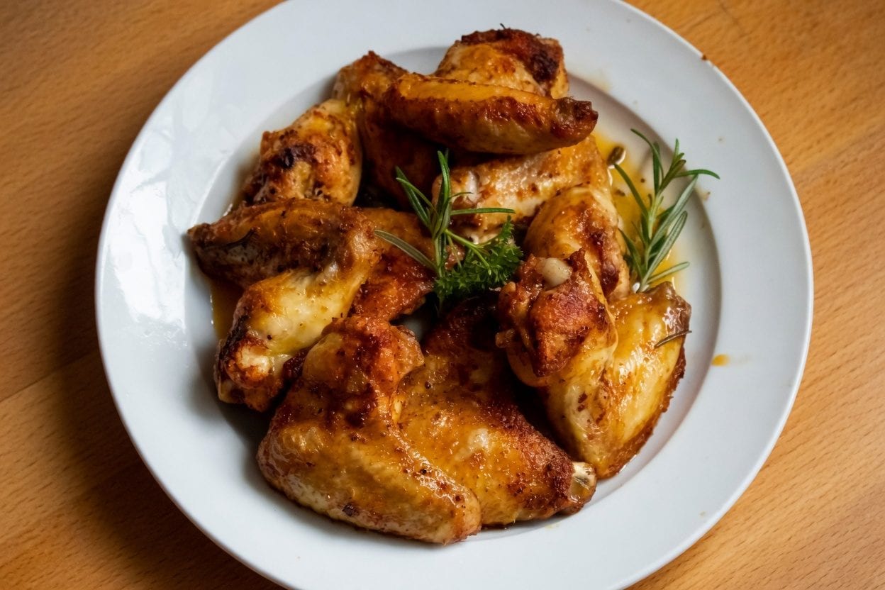 Plate of roasted wings on a white dish