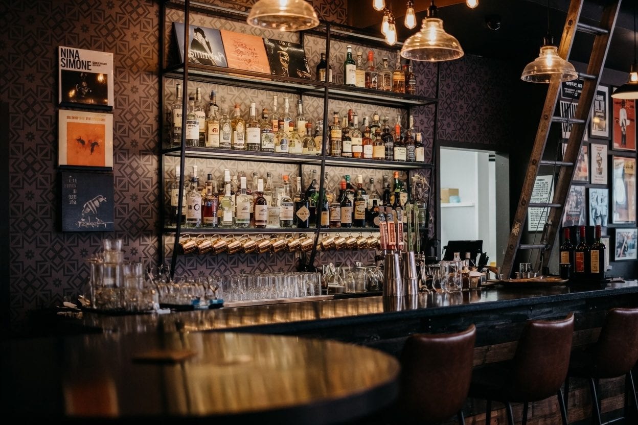 Dark cocktail-style bar interior in Little Italy