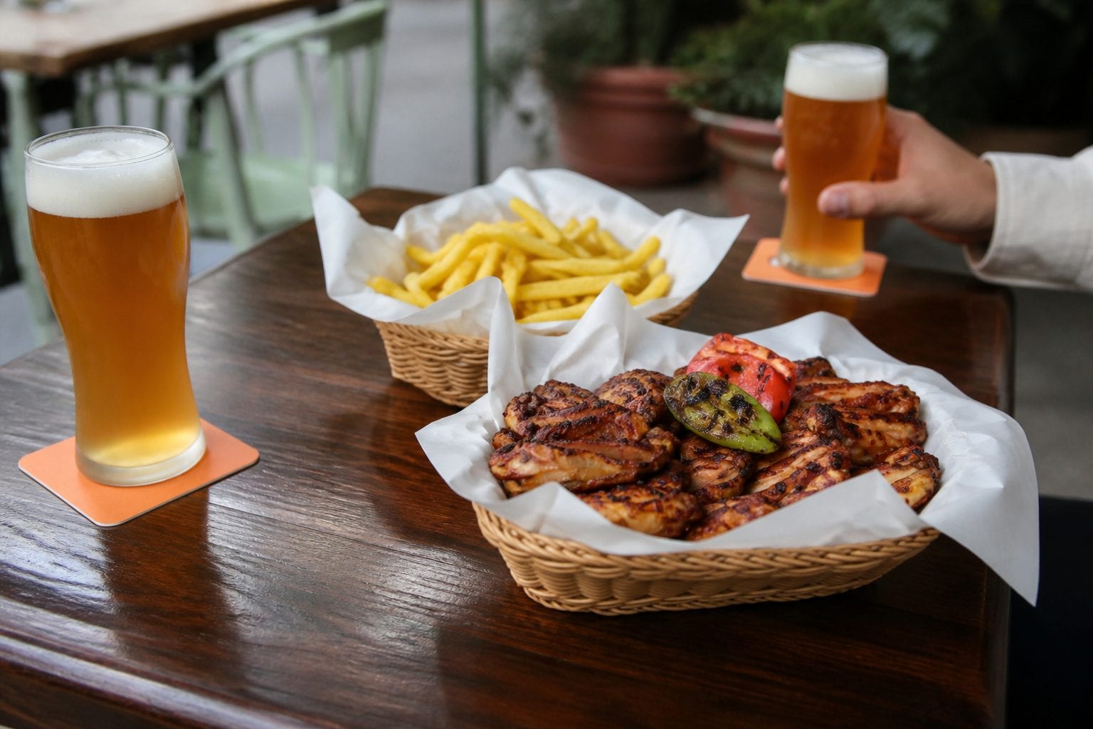 Wings and pints set out on a pub table